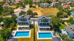 an aerial view of a house with two swimming pools at Cesur Villa 2 in Fethiye