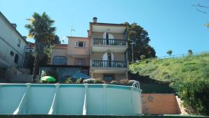 a house with a swimming pool in front of a building at A morada do peregrino in Poio