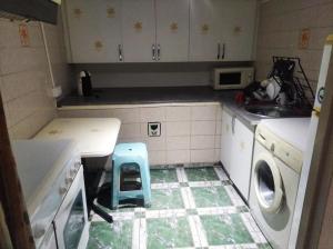 a kitchen with a sink and a washing machine at A morada do peregrino in Poio