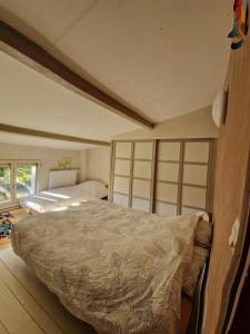 a bedroom with a large bed in a room at Gîte du Séquoia - Paisible maison de campagne in Vallet +23 photos