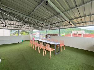 a room with a table and chairs on a roof at Aarna Villa nr Valvan Dam in Lonavala