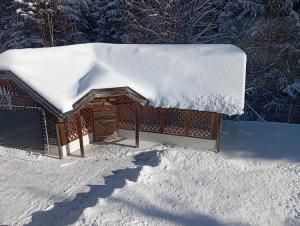 a snow covered roof of a house with snow on it at Ferienhaus Wimmer in Faistenau +38 photos