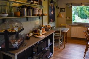a kitchen with a counter with food on it at Pension Trent in Trent
