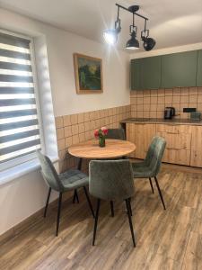 a kitchen with a table and chairs in a room at Срібний ключ in Mukacheve +8 photos