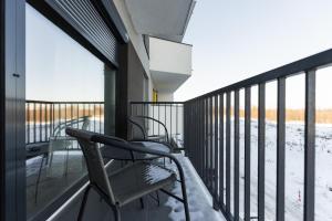 a balcony with chairs and snow on it at Royalton Suites in Cluj-Napoca