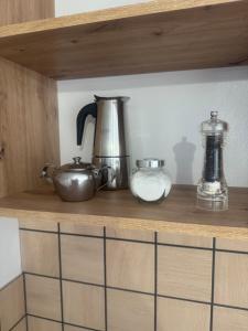a shelf with some pots and pans on it at Срібний ключ in Mukacheve