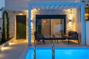 a villa with a swimming pool at night at Bela Villas in Kallithea Halkidikis +37 photos