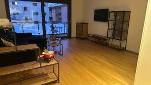 a living room with a couch and a television at Bergperle in Grächen