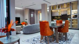a dining room and living room with a table and chairs at ارتاما بوتيك للشقق المخدومة in Riyadh +50 photos