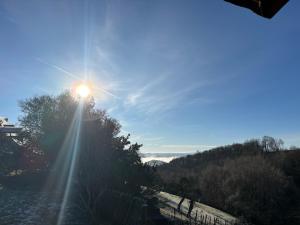 a sun is shining on a hill with trees at Lacouty le paradis! in Junhac