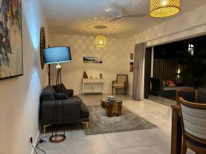 a living room with a couch and a table at Point de Mire in Rivière Noire