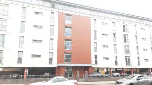 two cars parked in front of a building at Elegant three bedroom flat in Darlington