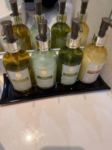 a group of bottles sitting on top of a sink at ホテルメイプル in Odate