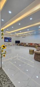 a large room with a lobby with couches and a television at Al Barari Farm & Resorts Al Ain in ‘Ayn al Fayḑah