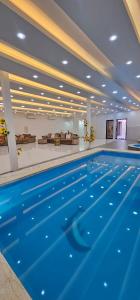 a large swimming pool in a large building with at Al Barari Farm & Resorts Al Ain in ‘Ayn al Fayḑah