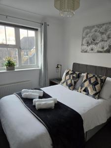 a bedroom with two beds with towels on them at The Flexible Lodge-Ashford in Kingsnorth