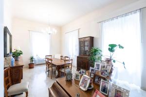 a living room with a table and a dining room at Villa Olivieri 1928 in Ascoli Piceno