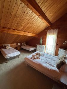 a bedroom with a large bed with a girl laying on it at Chalet Tramontane, gîte tout confort in Xonrupt-Longemer