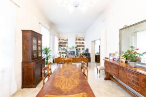 a dining room with a wooden table and chairs at Villa Olivieri 1928 in Ascoli Piceno