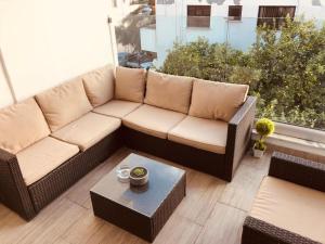 a living room with a couch and a table at Midtown Napa Apartments in Ayia Napa