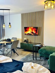 a living room with a fireplace in the wall at Ankommen & wohlfühlen - Ihr stilvolles Zuhause in Dresden