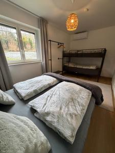 two beds sitting in a room with a window at Geräumiges Apartment No 3 in Fulda mit Klima in Fulda +4 photos