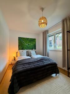 a bedroom with a large bed with a painting on the wall at Geräumiges Apartment No 3 in Fulda mit Klima in Fulda