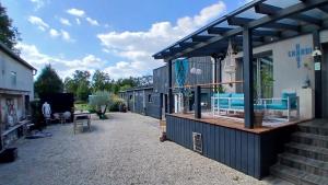 a building with a patio with blue chairs on it at Auszeit by kirschner in Mönchhof