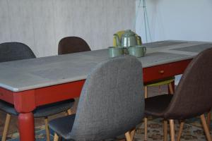 a table with chairs and a tea kettle on it at Auszeit by kirschner in Mönchhof