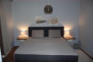 a bedroom with a large bed with two night stands at Auszeit by kirschner in Mönchhof +37 photos