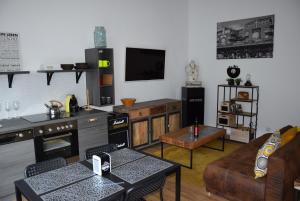 a kitchen and living room with a couch and a table at Auszeit by kirschner in Mönchhof
