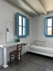 a room with a bed and a mirror and a chair at Astra Serifos in Livadi +133 photos