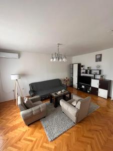 a living room with a couch and two chairs and a table at Devetka in Pirot