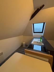 a small kitchen with a sink and a window at Appartement Numéro 3, centre chateau-renault in Château-Renault +1 photo