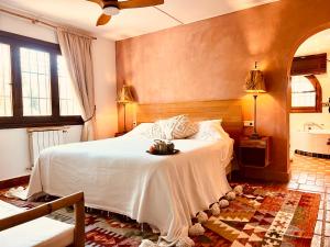 a bedroom with a white bed in a room at Boutique Finca Stay in Nature in Mijas