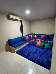a blue couch with colorful pillows in a room at Chacará Village do Rio Ouro in Conde +46 photos