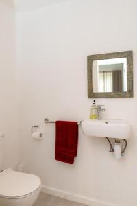a bathroom with a toilet and a sink and a mirror at Point de Mire in Rivière Noire +30 photos