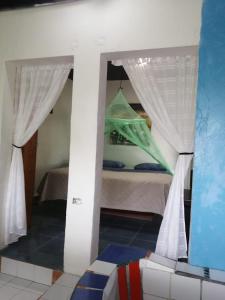 a view of a room with a bed and a mirror at Cabañas y café Kauani in El Guayabo