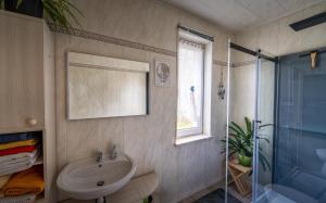 a bathroom with a sink and a shower at Gästehaus Barthel in Gosen +10 photos