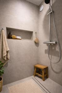 a bathroom with a shower with a bench and a stool at Solange by Port Azur Rental in Cogolin +2 photos