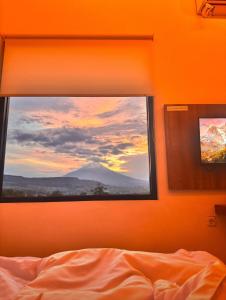 a bedroom with a window with a view of a mountain at SALU AMAANA Residence Syariah in Wonosobo