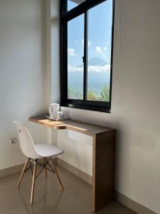 a desk with a chair and a window at SALU AMAANA Residence Syariah in Wonosobo