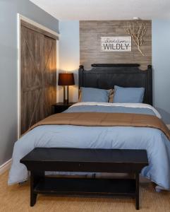 a bedroom with a large bed with a wooden headboard at Condo Loft at Blue Mountain in Blue Mountains