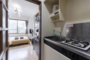 a small kitchen with a sink and a stove at Kunark KM102 Stay in Kokubunji