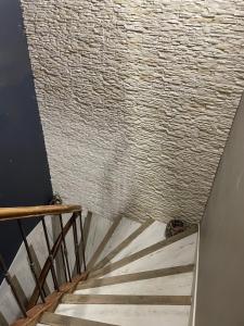 a stairway with a brick wall and a stair case at Les Vieux Platanes Loft chaleureux in La Crau