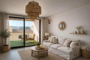 a living room with a white couch and a table at Solange by Port Azur Rental in Cogolin
