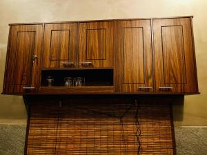 a wooden cabinet with glasses on top of it at Villa Stillrock in Dodanduwa