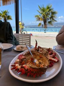 a plate of food sitting on a table with a meal at Casa Arealonga in Vigo