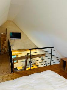a bedroom with a bed and a tv in a attic at Dépendance chez l'habitant in Morlaix