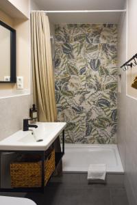 a bathroom with a shower and a sink and a tub at Pension Trent in Trent +65 photos